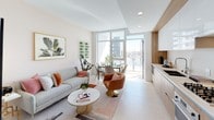 Located at 1201 S Hope St in the heart of Los Angeles, this thoughtfully designed unit offers a seamless blend of modern aesthetics and functional living. The open-plan living and dining area is anchored by large floor-to-ceiling windows and a sliding glass door that leads to a private balcony, flooding the space with natural light and framing sweeping views of the Los Angeles skyline. The living area features light tile flooring, recessed lighting, and a warm, contemporary palette accented with terracotta and blush tones.

The kitchen runs efficiently along one wall, showcasing flat-front cabinetry in a warm wood tone complemented by white upper cabinets, a gas cooktop, and clean white countertops — a practical yet polished space for cooking and entertaining.

The bedroom is a tranquil retreat finished with wood flooring, a ceiling fan, soft gray accent walls, and warm gold metallic wall art. Boho-inspired décor adds personality and warmth to the space.

The bathroom is finished with large-format beige stone-look tiles throughout, a soaking tub with an integrated shower, a wood-vanity with a wide mirror featuring ambient underlighting, and open shelving — combining spa-like serenity with everyday functionality.