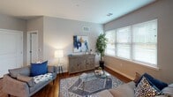 This single-floor residence on Lexington Boulevard in Glenmoore, PA offers a thoughtfully designed layout with a cohesive, contemporary aesthetic throughout. Rich hardwood flooring connects the main living areas, complemented by neutral gray walls that create a calm, unified atmosphere.

The kitchen is a functional centerpiece, featuring white shaker cabinetry, a classic subway tile backsplash, and a full suite of stainless steel appliances including a gas range, built-in microwave, and a full-size refrigerator. A peninsula with seating for two is illuminated by a pair of pendant lights, making it ideal for casual dining or entertaining. Abundant natural light enters through multiple windows fitted with horizontal blinds.

The open living and dining area is generously proportioned, accommodating both a seating arrangement and a dining table with ease. Two large windows flood the space with natural light, while a ceiling fan adds comfort. The layout flows naturally between zones, enhancing the sense of openness.

Both bedrooms are comfortably sized, each featuring multiple windows for natural light and neutral carpet or hard flooring. The bathroom is clean and modern, with a shaker-style vanity, gray countertop, large framed mirror, and warm wood-look flooring.