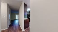 This 910 square foot apartment in Hendersonville, TN, offers a well-designed living space with two bedrooms and three bathrooms. The single-story layout maximizes efficiency, featuring a modern kitchen, dining room, living room, and in-unit laundry facilities. The primary bedroom, measuring 140 square feet, provides ample space for comfort.

Throughout the apartment, rich wood-look flooring creates a warm and inviting atmosphere. Large windows and French doors in the living area allow natural light to flood the space, while offering access to an outdoor area. The kitchen boasts dark wood cabinetry, granite countertops, and matching black appliances, creating a sleek and cohesive look.

Both bedrooms feature ceiling fans and windows with blinds for light control and privacy. The bathrooms are equipped with modern fixtures, including a bathtub with built-in shelving and a separate shower stall. Storage solutions are plentiful, with walk-in closets and additional shelving in various rooms.

The apartment's neutral color palette and clean lines contribute to a contemporary feel, making it easy for residents to personalize their space. With its thoughtful design and range of amenities, this apartment offers a comfortable and functional living environment in a desirable location.