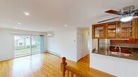 Located at 7940 Janes Ave in Woodridge, IL, this 2-bedroom, 1-bathroom residence offers a well-designed, single-floor layout that maximizes comfort and functionality. Warm hardwood flooring runs throughout the entire space, creating a cohesive and inviting atmosphere.

The open-concept living room is bright and airy, with recessed lighting, a wall-mounted mini-split HVAC unit, and a sliding glass door that leads to a private balcony overlooking a pleasant outdoor view. Baseboard heating provides additional climate control throughout the home.

The kitchen flows seamlessly from the living area and features rich wood cabinetry with glass-front upper cabinets, dark granite countertops, stainless steel appliances, and a ceiling fan overhead — offering both style and practicality.

The primary bedroom is generously sized, equipped with a ceiling fan, a wall-mounted mini-split unit, and a window framing views of the surrounding neighborhood. The second bedroom is a comfortable, well-lit space with hardwood floors and easy access to the hallway.

The bathroom area includes marble-look tile flooring, a white vanity with marble-style countertop, and a stacked washer/dryer unit conveniently located nearby. A dedicated closet completes the layout, adding valuable storage to this thoughtfully arranged home.