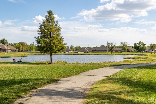 A peaceful park in Owasso, where a person finds solace in a good book.