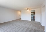 Located at 4402 Bell St in Amarillo, Texas, this single-floor unit offers a practical and comfortable layout designed for everyday living. The kitchen is well-equipped with warm-toned wood cabinetry providing ample upper and lower storage, light-colored countertops, a built-in dishwasher, a white range, and a full-size refrigerator. Stone-look tile flooring runs throughout the kitchen, adding a clean and durable surface underfoot. The living area is generously sized, featuring wall-to-wall carpeting and a sliding glass door that invites natural light and outdoor views. The bedrooms are carpeted and offer a comfortable sense of space, with windows dressed in horizontal blinds that allow for natural light. One bedroom includes a reach-in closet with organizational capacity. The unit features two bathrooms: one includes a full tub-shower combination with white surround, a vanity with warm stone-toned countertop, white cabinetry, and mosaic tile flooring; the second bathroom features a similar vanity setup with a mirror medicine cabinet. Textured ceilings are consistent throughout the unit, contributing to the home's classic character. The overall layout is functional and well-organized, making this a practical option in the Amarillo area.