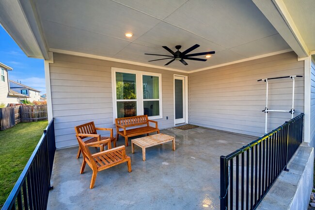 Extended covered back patio with gas hookup for grilling, overlooking a peaceful greenbelt. - 517 Moonlit Stream Pass