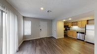 Located at 4041 Bluemel Rd in San Antonio, TX, this single-floor unit offers a clean, functional layout designed for comfortable everyday living. Rich, dark wood-style flooring runs throughout the space, providing a cohesive and polished look from room to room.

The open living area is bright and welcoming, with a sliding glass door that invites natural light and provides access to the outdoors. An additional window near the entryway further enhances the airy feel of the main living space. Textured ceilings and neutral-toned walls create a simple, understated backdrop throughout.

The kitchen is well-equipped and efficient, featuring warm honey-toned cabinetry, granite countertops, and a full suite of stainless steel appliances including a range, microwave, dishwasher, and refrigerator. The layout maximizes functionality while connecting seamlessly to the living area.

The bathroom continues the cohesive design aesthetic with a granite-topped vanity, warm wood cabinetry, a large mirror, and wood-style flooring. A separate water closet area adds a practical touch. The unit also includes a keypad-secured entry door, offering added convenience and security. Overall, the space presents a tidy, move-in-ready environment with consistent finishes throughout.
