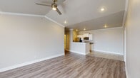 Located at 4441 E 46th St in North Little Rock, AR, this single-story, 2-bedroom, 2-bathroom home offers a well-designed open-concept layout with modern finishes throughout. The living room features vaulted ceilings with crown molding, recessed lighting, a ceiling fan, and a tiled fireplace, creating a warm and inviting focal point. Light wood-look flooring flows through the main living areas, complementing the neutral color palette. The kitchen is outfitted with white cabinetry, granite countertops, stainless steel appliances including a range, microwave, and refrigerator, and a peninsula that opens to the living space. The spacious primary bedroom includes vaulted ceilings, a ceiling fan, and abundant natural light from large windows. The second bedroom also features a ceiling fan and a window with natural light. Both bathrooms include granite vanity countertops and tiled tub-shower combinations. A dedicated laundry room provides added convenience with cabinetry for storage. Each bedroom includes its own closet, and the home benefits from a practical, efficient floor plan that maximizes the available living space.