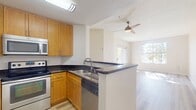 This 570 square foot apartment in San Jose, CA, offers a thoughtfully designed living space with modern amenities. The single-floor layout comprises one bedroom, one bathroom, and an open-concept kitchen and living area. The primary bedroom, measuring 140 square feet, provides ample space for rest and relaxation.

The apartment boasts bright, airy interiors enhanced by large windows and sliding glass doors that flood the space with natural light. These doors lead to a private patio, extending the living area outdoors. Throughout the apartment, light-toned wood flooring creates a cohesive and contemporary aesthetic.

The kitchen features honey-colored wood cabinetry, contrasting dark countertops, and stainless steel appliances, including a built-in microwave. The bathroom is equipped with a shower-tub combination and a wooden vanity, maintaining the apartment's modern design language.

The living area is versatile, offering space for both dining and lounging. Built-in closets in the bedroom provide storage solutions. The neutral color palette of cream walls and white trim creates a blank canvas for personal style, while the abundance of natural light enhances the sense of spaciousness in this compact yet efficiently designed apartment.