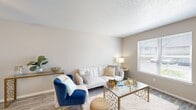 Located at 12700 Indian Creek Blvd in Oklahoma City, OK, this one-bedroom, one-bathroom residence offers a thoughtfully arranged single-floor layout designed to maximize comfort and functionality. The living room serves as the heart of the home, featuring durable wood-look flooring, a textured ceiling, a ceiling fan, and a large window that allows natural light to fill the space, creating an airy and inviting atmosphere. The kitchen is well-equipped with gray shaker-style cabinetry, white quartz-style countertops, a black electric range, a dishwasher, and a stainless steel refrigerator, all set on easy-care tile-look flooring. The spacious bedroom accommodates a king-size bed comfortably, complete with its own large window offering outdoor views, wood-look flooring, and direct access to a dedicated closet. The full bathroom features a tub-shower combination with white tile surround, a gray vanity with a light stone-style countertop, and matching wood-look flooring for a cohesive look. Additional spaces include an entrance, hallway, and a utility room, rounding out a practical and complete floor plan. The neutral color palette throughout lends the home a clean, modern aesthetic.