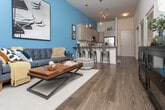 Located at 1133 Commerce Dr in Decatur, GA, this single-floor unit offers a thoughtfully designed layout with modern finishes throughout. The kitchen serves as a standout feature, showcasing sleek flat-front cabinetry in a warm gray tone, a large central island with granite countertops, stainless steel appliances including a French door refrigerator, built-in microwave, and range, complemented by a classic white subway tile backsplash and rich hardwood flooring. Pendant lighting overhead adds a contemporary touch to the open kitchen space. The bedrooms are carpeted for comfort, each featuring windows with blinds that allow natural light to filter in, and ceiling fans to enhance airflow. The bathrooms are clean and functional, finished with granite-topped vanities, framed mirrors, brushed nickel fixtures, and tiled tub and shower combinations with white square tile surrounds. Hardwood flooring extends through the main living areas, creating a cohesive and polished look. The overall design of the space balances modern aesthetics with practical functionality, offering a comfortable and well-finished environment in a convenient Decatur location.