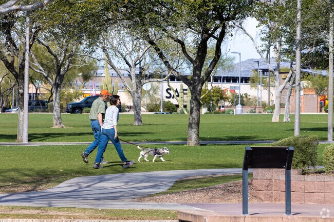 Anthem residents take their dog for a walk through Anthem Community Park.