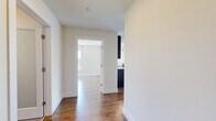 Located at 410 Court Street in Lynchburg, VA, this well-appointed 2-bedroom, 2-bathroom residence offers a thoughtfully designed single-floor layout. Warm hardwood-style flooring flows throughout, complemented by crisp white walls and clean white baseboards that give the space a bright, modern feel.

The kitchen is a standout feature, boasting striking granite countertops with bold veining, rich dark cabinetry, a subway tile backsplash, stainless steel appliances including a refrigerator, range, and microwave, and a peninsula with an undermount sink — ideal for both cooking and casual dining. The adjacent living room is generously proportioned, filled with natural light from multiple windows, and topped with a ceiling fan for year-round comfort.

The primary bedroom is a well-sized retreat with hardwood-style flooring, a ceiling fan, and a window offering views of the surrounding hillside. The second bedroom is bright and airy, featuring large windows with views of the Lynchburg cityscape. Both bathrooms are clean and functional, with one featuring a full soaking tub and shower combo with chrome fixtures and tile flooring. Additional storage is provided by a dedicated closet. The overall ambiance is clean, contemporary, and move-in ready.