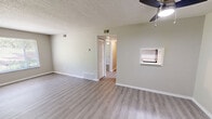 Located on University Blvd in Kingsport, Tennessee, this single-floor, 3-bedroom, 1-bathroom home offers a clean and functional layout with modern updates throughout. Light-toned luxury vinyl plank flooring runs consistently across the living spaces, complemented by neutral beige and gray wall tones and crisp white trim that create a bright, cohesive atmosphere.

The living room is a comfortable, open space featuring a ceiling fan with light fixture and a pass-through window connecting to the kitchen, adding a sense of openness. The kitchen is equipped with white cabinetry, laminate countertops, a stainless steel single-basin sink, and a dishwasher, offering a practical and tidy cooking area.

Each of the three bedrooms benefits from natural light provided by windows with blinds that offer views of lush, green outdoor scenery. The primary bedroom includes a closet with louvered doors and its own ceiling fan. The additional bedrooms are well-sized with ample wall space. Two closets provide convenient storage throughout the home.

The full bathroom features a tub and shower combination with clean white tile surround. A central hallway connects the bedrooms and bathroom. Textured ceilings are consistent throughout. The overall ambiance is clean, neutral, and move-in ready.