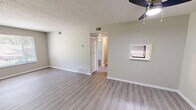 Located on University Blvd in Kingsport, Tennessee, this single-floor, 3-bedroom, 1-bathroom home offers a clean and functional layout with modern updates throughout. Light-toned luxury vinyl plank flooring runs consistently across the living spaces, complemented by neutral beige and gray wall tones and crisp white trim that create a bright, cohesive atmosphere.

The living room is a comfortable, open space featuring a ceiling fan with light fixture and a pass-through window connecting to the kitchen, adding a sense of openness. The kitchen is equipped with white cabinetry, laminate countertops, a stainless steel single-basin sink, and a dishwasher, offering a practical and tidy cooking area.

Each of the three bedrooms benefits from natural light provided by windows with blinds that offer views of lush, green outdoor scenery. The primary bedroom includes a closet with louvered doors and its own ceiling fan. The additional bedrooms are well-sized with ample wall space. Two closets provide convenient storage throughout the home.

The full bathroom features a tub and shower combination with clean white tile surround. A central hallway connects the bedrooms and bathroom. Textured ceilings are consistent throughout. The overall ambiance is clean, neutral, and move-in ready.