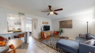Located in Palm Bay, Florida, this single-story, one-bedroom, one-bathroom residence offers a thoughtfully designed layout with modern finishes throughout. The living room is bright and welcoming, featuring wood-look flooring, a textured ceiling with a ceiling fan, and large windows dressed with vertical blinds that invite natural light while offering views of the lush greenery outside. An accent wall adds a pop of color, enhancing the contemporary aesthetic of the space.

The kitchen is well-equipped with grey shaker-style cabinetry, granite countertops, a white subway tile backsplash, and stainless steel appliances, including a full-size refrigerator and dishwasher. A breakfast bar provides additional seating and connects the kitchen to the living and dining areas.

The generously sized bedroom features plush carpet flooring, a calming teal accent wall, and a sliding glass door that opens directly to a private outdoor patio surrounded by tropical landscaping. A dedicated closet offers practical storage.

The bathroom is finished with a granite-topped vanity, wood-look tile flooring, and a large mirror, creating a clean and functional space. Throughout the residence, the cohesive design palette and quality finishes reflect a comfortable and modern Florida lifestyle.