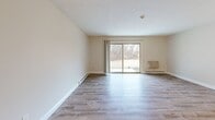 Located at 1 Apple Rd in Beverly, MA, this single-floor, 2-bedroom, 3-bathroom residence offers a well-organized and functional layout. The living room is a bright, open space highlighted by sliding glass doors that frame views of the surrounding wooded landscape, flooding the room with natural light. Durable hardwood-style flooring runs throughout the main living areas, complemented by baseboard heating and a textured ceiling.

The kitchen features white cabinetry with brushed nickel hardware, granite-style countertops, white appliances including a dishwasher, and a classic subway tile backsplash, creating a clean and practical cooking space.

The primary bedroom is generously sized, with carpeted flooring, a window overlooking the natural surroundings, and ample wall space. The second bedroom also features carpet, a window with outdoor views, and baseboard heating. A built-in shelf adds a practical touch to one of the bedrooms.

The three bathrooms include a compact half-bath with a round mirror, white vanity, and brushed nickel fixtures, as well as additional full bathrooms equipped with a tub-shower combination. A dedicated closet provides convenient storage. The overall ambiance is clean, neutral, and move-in ready.