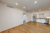 Located at 8500 Old Redwood Hwy in Windsor, CA, this well-designed one-bedroom, one-bathroom residence offers a clean, modern aesthetic across a single floor. The open-concept layout seamlessly combines the living room, dining area, and kitchen into one cohesive space, making efficient use of the floor plan. Recessed lighting and crisp white walls create a bright, airy atmosphere throughout.

The kitchen is a standout feature, equipped with a full suite of stainless steel appliances including a refrigerator, electric range, and dishwasher. White shaker-style cabinetry with sleek hardware lines the walls, complemented by granite countertops that add a touch of elegance. Light wood-style luxury vinyl plank flooring runs throughout the entire unit, providing a warm, cohesive look.

The bedroom is a comfortable retreat, benefiting from multiple windows that invite natural light and provide views of the surrounding greenery. A sliding-door closet offers convenient storage, and direct access to the bathroom adds practicality. The bathroom features a tiled shower-tub combination with a curved curtain rod and a window for natural ventilation. Two closets throughout the unit provide ample additional storage. The overall ambiance is clean, contemporary, and move-in ready.