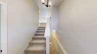This contemporary residence in Traverse City offers 1560 square feet of living space across two floors. The home boasts three bedrooms, including a spacious 170 square foot primary suite, and three full bathrooms. The ground floor, measuring 820 square feet, features an open-concept kitchen and living room area with sleek hardwood flooring and ample natural light. The kitchen is equipped with modern stainless steel appliances and white cabinetry. A convenient laundry room with top-loading washer and dryer is also present. The upper level, spanning 740 square feet, houses the bedrooms, showcasing plush carpeting for comfort. Bathrooms are outfitted with modern fixtures, including a tub-shower combination with a sliding glass door. The home's bright and airy ambiance is enhanced by recessed lighting throughout and large windows, some offering access to outdoor spaces. Additional amenities include a garage and multiple closets for storage. The neutral color palette and clean lines contribute to the home's contemporary aesthetic, making it an ideal choice for those seeking a modern living space in Traverse City.