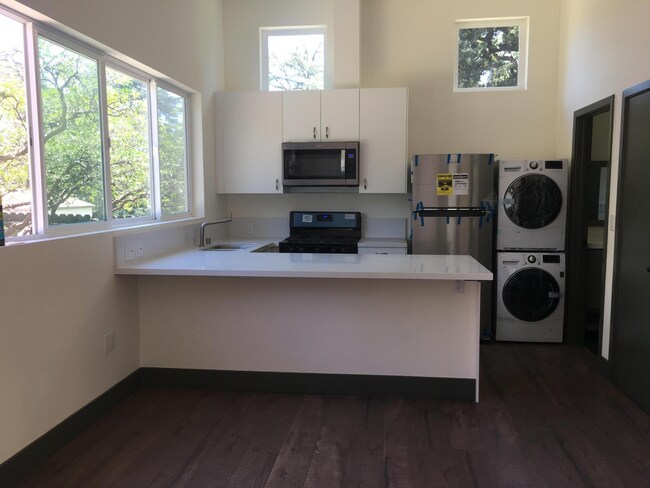 Bright living space is divided into comfortable kitchen with quart counters. - 221 Wapello St