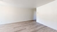 Located at 1701 Ellis Lake Drive in Marysville, California, this one-bedroom, one-bathroom unit offers a practical and comfortable single-floor layout. The open-concept living room and kitchen area forms the heart of the home, finished with light-toned luxury vinyl plank flooring that lends a clean, contemporary feel throughout. The kitchen is equipped with warm wood cabinetry, a white speckled countertop with a peninsula-style breakfast bar, a stainless steel sink, black appliances including a refrigerator and gas range, and overhead cabinet storage — all centered around a window that brings in natural light. The living area is bright and open with crisp white walls and ample space for flexible furniture arrangements. The bedroom is a well-proportioned, carpeted retreat with a window overlooking the outdoors, providing natural light and a peaceful ambiance. A dedicated closet offers convenient storage. The full bathroom features warm wood vanity cabinetry, a wide countertop with an integrated sink, a large mirror with overhead lighting, a medicine cabinet, and light wood-tone flooring. Ceiling vents provide central air circulation throughout the unit. Clean, neutral finishes make this a move-in-ready space suitable for a variety of living styles.