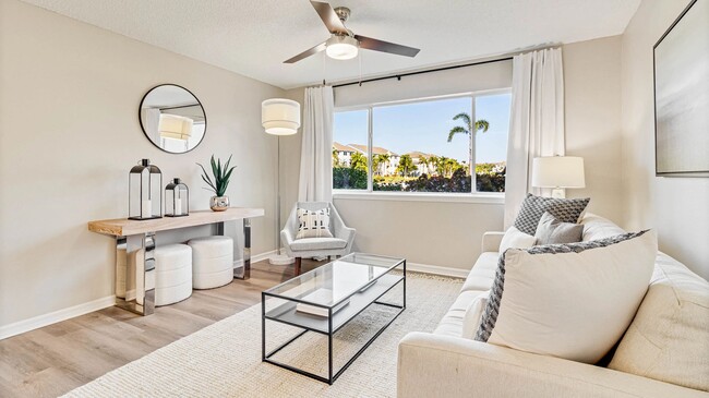 Bright living spaces with large windows and cheerful ceiling fans for an uplifting vibe. - Lexington Palms at the Forum