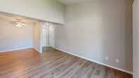 Located at 5109 Andrea Blvd in Sacramento, CA, this one-bedroom, one-bathroom unit offers a well-designed single-floor layout with a clean, modern aesthetic throughout. Light-toned vinyl plank flooring runs continuously across the living areas, kitchen, bedroom, and hallway, lending a cohesive and easy-to-maintain finish to the entire space.

The combined kitchen and living area forms the heart of the unit. The galley-style kitchen is outfitted with white upper and lower cabinetry featuring contemporary black hardware, light granite-style countertops, a stainless steel sink, and white appliances including an electric range and refrigerator. The open living room receives generous natural light and provides direct access to a private balcony through a sliding glass door, offering pleasant outdoor views of the surrounding greenery.

The spacious bedroom is a standout feature, offering notable square footage with two louvered bi-fold closets providing ample storage. A window dressed with blinds allows natural light to filter in, creating a comfortable and well-lit retreat.

The bathroom is finished with a clean, all-white tub and shower combination with chrome fixtures and a built-in shelf, complemented by neutral wall tones and wood-look flooring. A hallway connects the main living spaces, completing this practical and inviting layout.