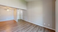 Located at 5109 Andrea Blvd in Sacramento, CA, this one-bedroom, one-bathroom unit offers a well-designed single-floor layout with a clean, modern aesthetic throughout. Light-toned vinyl plank flooring runs continuously across the living areas, kitchen, bedroom, and hallway, lending a cohesive and easy-to-maintain finish to the entire space.

The combined kitchen and living area forms the heart of the unit. The galley-style kitchen is outfitted with white upper and lower cabinetry featuring contemporary black hardware, light granite-style countertops, a stainless steel sink, and white appliances including an electric range and refrigerator. The open living room receives generous natural light and provides direct access to a private balcony through a sliding glass door, offering pleasant outdoor views of the surrounding greenery.

The spacious bedroom is a standout feature, offering notable square footage with two louvered bi-fold closets providing ample storage. A window dressed with blinds allows natural light to filter in, creating a comfortable and well-lit retreat.

The bathroom is finished with a clean, all-white tub and shower combination with chrome fixtures and a built-in shelf, complemented by neutral wall tones and wood-look flooring. A hallway connects the main living spaces, completing this practical and inviting layout.
