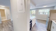 Located at 840 Trillium Park in Sarnia, Ontario, this thoughtfully updated one-bedroom, one-bathroom unit offers a clean, modern aesthetic throughout its efficiently organized single-floor layout. Light wood-tone laminate flooring flows seamlessly through every room, complementing the neutral palette of soft whites and warm greiges that define the interior.

The open-concept living and kitchen area serves as the heart of the unit. The kitchen features white shaker-style cabinetry, a marble-look stone countertop with a peninsula breakfast bar, stainless steel appliances including a full-size refrigerator and range, and subway tile backsplash accents. Recessed lighting adds a polished finish overhead. The adjoining living area is bright and airy, enhanced by a sliding glass door that opens to a private balcony with views of surrounding greenery, alongside an additional side window that draws in natural light.

The bedroom is a comfortable, well-sized space with a large window framing leafy outdoor views, light wood flooring, and neutral walls that create a calm, restful atmosphere. The bathroom is clean and functional, featuring a full soaker tub with an overhead shower and bright white tile surround. Throughout the unit, crisp white baseboards and consistent finishes contribute to a cohesive, move-in-ready presentation.
