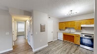 Located at 160 Stateline Rd in Clarksville, Tennessee, this single-story, 2-bedroom, 1-bathroom home offers a practical and well-organized layout. The interior features consistent hardwood-style vinyl plank flooring throughout, neutral gray-toned walls, and textured ceilings, creating a cohesive and clean aesthetic.

The kitchen is well-appointed with warm oak cabinetry offering ample upper and lower storage, white countertops, a double-basin sink, a stainless steel electric range, a dishwasher, and a full-size black refrigerator. A stylish multi-arm ceiling light fixture adds a modern touch to the space.

The bedrooms are comfortably sized, with the primary bedroom providing a generous footprint and a double-door closet for storage. Each bedroom includes hardwood-style flooring and windows with blinds that allow for natural light. One bedroom also features a ceiling fan with a light fixture, enhancing comfort and airflow.

A dedicated laundry area accommodates a stacked washer and dryer unit, adding everyday convenience. The bathroom is clean and functional, featuring a tub-shower combination with a grab bar, a toilet, and a vanity with a sink.

The home's straightforward single-floor design, ample storage, and practical amenities make it a well-suited residence in the Clarksville area.