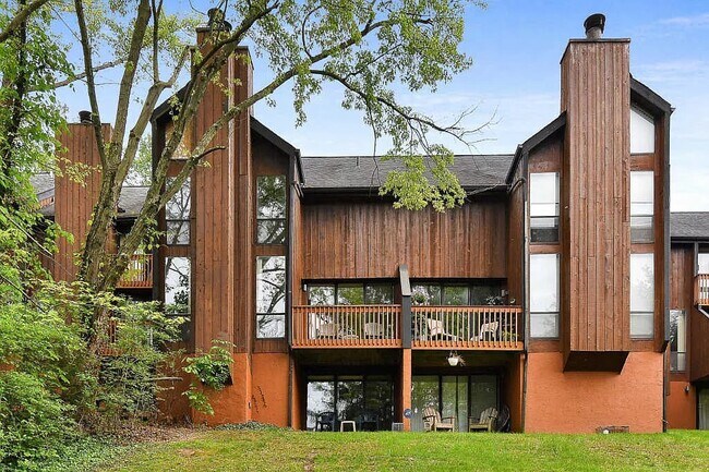 Rear photo. Shows balcony & walk-out. - 4830 Crazy Horse Ln
