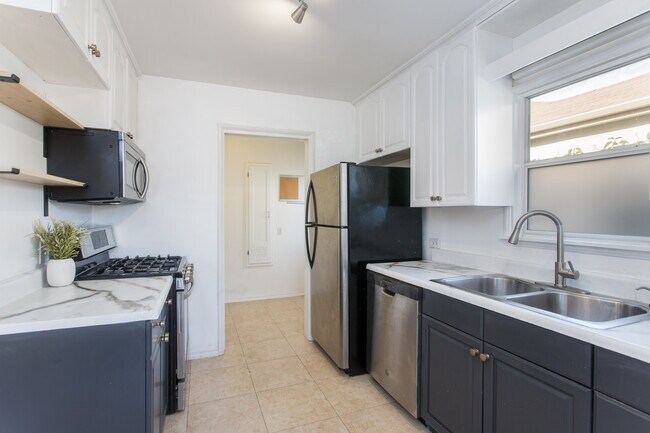 Kitchen was just updated - new counters, hardware, lighting. Modern stainless steel appliances. - 205 6th Ave