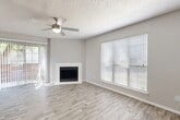 Located at 600 Legacy Dr in Plano, Texas, this well-appointed 2-bedroom, 4-bathroom single-story home offers a thoughtfully designed layout across a comfortable footprint. The open-concept living and dining area serves as the heart of the home, featuring light-toned wood-style flooring, a ceiling fan, a textured ceiling, and a clean white fireplace flanked by large windows with horizontal blinds that invite abundant natural light. A sliding glass door provides direct outdoor access, enhancing the airy feel of the space. The kitchen is a standout feature, boasting a generous center island with a double sink, sleek quartz-style countertops, white cabinetry, stainless steel appliances, and a view into the living area that supports easy entertaining. An in-unit laundry room with a full-size washer and dryer adds everyday convenience. The two bedrooms are well-sized, with the primary bedroom offering a spacious layout, plush carpeting, and ample natural light. Additional bedrooms also feature ceiling fans and bright windows. The four bathrooms maintain a clean, functional design with tub-shower combinations and wood-style flooring. Two closets and a hallway complete the efficient floor plan, making this home practical and comfortable throughout.