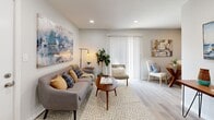This single-floor residence at 13001 E 40th St in Tulsa, Oklahoma, offers a thoughtfully designed layout with cohesive, modern finishes across each room. The living area serves as the heart of the unit, featuring light hardwood-style flooring, recessed lighting, and a sliding glass door that invites natural light and provides access to the outdoors. Neutral gray walls create a versatile backdrop, complemented by warm mid-century modern furnishing arrangements that enhance the space's inviting ambiance.

The kitchen is efficiently arranged with rich dark wood cabinetry, granite countertops, and a full suite of stainless steel appliances, including a refrigerator, range, microwave, and dishwasher. Light wood-style flooring continues throughout, tying the space together with a clean, contemporary aesthetic.

The bedroom is a calm retreat, highlighted by soft neutral tones, a large window fitted with white blinds that allow ample natural light, and wood-style flooring underfoot. The bathroom is well-appointed, featuring a tub-shower combination with large-format marble-look tile surround, a granite-top vanity with dark wood cabinetry, and matching brushed nickel fixtures—creating a polished, cohesive finish throughout.