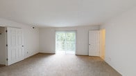 Located at 124 Southern Trce in Cincinnati, OH, this single-floor residence offers a well-organized layout designed for comfortable everyday living. The living room serves as the central gathering space, featuring neutral carpet, a textured ceiling, and a large sliding glass door fitted with vertical blinds that floods the room with natural light and provides direct access to an outdoor area overlooking lush, wooded greenery. A secondary door connects to adjacent rooms, contributing to smooth traffic flow throughout the unit.

The galley-style kitchen is efficiently arranged with warm wood cabinetry lining both sides, dark granite-toned countertops, and hardwood-style flooring. Stainless steel appliances — including a refrigerator, range, microwave, and dishwasher — provide functional appeal, while a double sink with ample counter space adds practicality.

The bedrooms are carpeted and generously sized, each featuring windows with vertical blinds that frame outdoor tree views, offering a calm and private atmosphere. The bathroom includes a full tub-and-shower combination with white tile surround, a wood-toned vanity with light countertop, and hardwood-style flooring. Throughout the space, neutral tones and consistent finishes create a cohesive, move-in-ready environment.