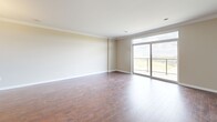 Located at 940 Springbank Dr in London, Ontario, this well-appointed 2-bedroom, 3-bathroom unit offers a thoughtfully designed single-floor layout with generous living space. The open-concept kitchen and living area forms the heart of the home, where warm hardwood flooring, elegant crown moulding, and neutral tones create a bright and welcoming atmosphere. The kitchen is equipped with stainless steel appliances, including a refrigerator, electric range, and built-in microwave, complemented by dark granite countertops, a central island with pendant lighting, and ample cabinetry in a warm wood finish. Large-format tile flooring grounds the kitchen space seamlessly.

The spacious primary bedroom features plush carpeting and a large window that frames sweeping treetop views, flooding the room with natural light. A second well-sized bedroom also features carpet flooring and a dedicated closet with built-in shelving. The bathrooms are finished with dark espresso cabinetry, granite countertops, dual undermount sinks, and large mirrors, exuding a clean, modern aesthetic. A dedicated laundry room with a stacked washer and dryer adds everyday convenience. Crown moulding throughout the living areas adds a refined architectural touch to this comfortable and functional home.