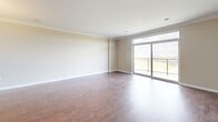 Located at 940 Springbank Dr in London, Ontario, this well-appointed 2-bedroom, 3-bathroom unit offers a thoughtfully designed single-floor layout with generous living space. The open-concept kitchen and living area forms the heart of the home, where warm hardwood flooring, elegant crown moulding, and neutral tones create a bright and welcoming atmosphere. The kitchen is equipped with stainless steel appliances, including a refrigerator, electric range, and built-in microwave, complemented by dark granite countertops, a central island with pendant lighting, and ample cabinetry in a warm wood finish. Large-format tile flooring grounds the kitchen space seamlessly.

The spacious primary bedroom features plush carpeting and a large window that frames sweeping treetop views, flooding the room with natural light. A second well-sized bedroom also features carpet flooring and a dedicated closet with built-in shelving. The bathrooms are finished with dark espresso cabinetry, granite countertops, dual undermount sinks, and large mirrors, exuding a clean, modern aesthetic. A dedicated laundry room with a stacked washer and dryer adds everyday convenience. Crown moulding throughout the living areas adds a refined architectural touch to this comfortable and functional home.