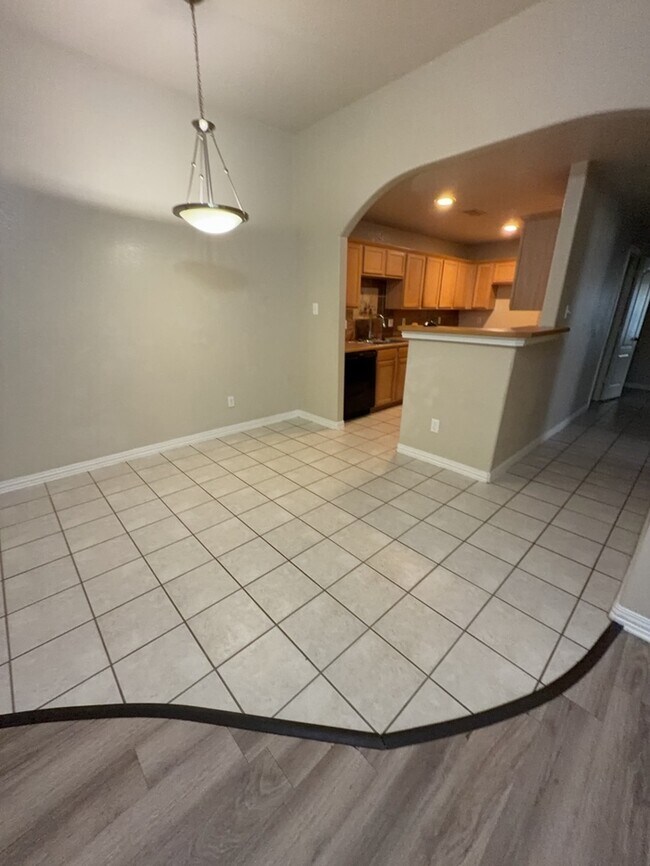 Building Photo - 3/2/2 features an open and inviting living and dining area, updated wood-look flooring, and a spa...