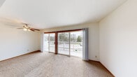 Located at 292 Lakeview Dr in Hartland, WI, this single-floor, one-bedroom, one-bathroom unit offers a comfortable and functional layout. The living area is spacious and filled with natural light, featuring neutral carpet flooring and a large sliding glass door that opens to a private balcony with a ceiling fan overhead — offering pleasant views of the surrounding trees and outdoor scenery. The galley-style kitchen is efficiently designed with warm oak cabinetry, white countertops, a double-basin sink, and tile flooring. A dedicated appliance area with open shelving provides additional storage and prep space, and the kitchen opens directly toward the living area, maintaining a connected feel throughout. The bedroom is generously sized, featuring carpet flooring, a sliding wood-paneled closet, and direct hallway access. Two hallways connect the rooms and contribute to the overall flow of the unit. The bathroom includes tile flooring, a full soaking tub with a shower surround, and a vanity with countertop space. Throughout the unit, the clean white walls, consistent finishes, and natural light create a bright, practical living environment well-suited for everyday comfort.