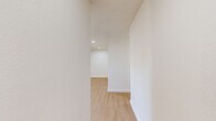This contemporary 890 square foot apartment in Santee, CA offers a well-designed living space with two bedrooms and two bathrooms. The open-concept layout creates a seamless flow between the living areas, enhancing the sense of spaciousness. Light wood-toned flooring runs throughout, complementing the crisp white walls and creating a bright, airy atmosphere.

The kitchen boasts modern white cabinetry, sleek stainless steel appliances, and quartz countertops, providing both style and functionality. Recessed lighting and ceiling fans in the bedrooms add to the overall comfort and ambiance. The primary bedroom, measuring 180 square feet, offers ample space for relaxation.

Both bathrooms feature updated fixtures, including glass shower enclosures and modern hardware. Large windows in the bedrooms and living areas allow for plenty of natural light, while also providing views of the surrounding area. The apartment's neutral color palette and clean lines create a canvas for various decorating styles, making it easy for residents to personalize their space. With its thoughtful design and contemporary finishes, this apartment offers a comfortable and stylish living environment in a desirable location.