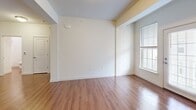 Located at 3214 Dunlap Ln in Mechanicsburg, PA, this one-bedroom, two-bathroom residence offers a well-designed single-floor layout that makes efficient use of its space. The open-concept kitchen and living area serves as the heart of the home, featuring rich hardwood-style flooring throughout. The kitchen is outfitted with white raised-panel cabinetry, granite and solid-surface countertops, and a full suite of stainless steel appliances, including a range, microwave, refrigerator, and dishwasher — providing both functionality and a clean, modern aesthetic.

The living area is bright and open, with windows that invite natural light and a neutral color palette that creates a welcoming ambiance. The generously sized bedroom is carpeted for comfort and includes a large walk-in closet with wire shelving systems that maximize storage. Both bathrooms are finished in crisp white, with one featuring a tub/shower combo with a curved curtain rod, and the other offering a vanity with a mirror and hardwood-style flooring. A dedicated utility room rounds out the layout. Throughout the home, consistent finishes and clean lines contribute to a cohesive, move-in-ready feel.