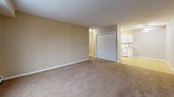 Located at 723 Kenwood Ave in Duluth, MN, this one-bedroom, one-bathroom unit offers a thoughtfully arranged single-floor layout with a comfortable and functional design throughout. The living room is generously proportioned, featuring wall-to-wall carpet, neutral beige tones, and a large picture window that frames views of surrounding wooded scenery, filling the space with natural light. A baseboard heating unit and a wall-mounted HVAC unit provide year-round climate control. The combined dining and kitchen area features hard surface flooring, white cabinetry, and an efficient layout that keeps cooking and dining in close proximity. The bedroom is a well-sized retreat finished with soft carpeting, a closet with double panel doors, and a window overlooking the natural landscape outside. The full bathroom offers tile flooring, a tub/shower combination, a vanity with white cabinetry, and clean, bright finishes throughout. A hallway connects the main areas of the unit, and notably, the space includes four closets in total, providing ample storage options. The overall ambiance is clean, neutral, and move-in ready, suited for comfortable everyday living in a quiet Duluth neighborhood.