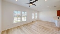 Located at 349 Ridge Rd in Lafayette, Louisiana, this single-story, 2-bedroom, 2-bathroom unit offers a thoughtfully designed layout with modern finishes throughout. Light wood-tone flooring flows consistently across all rooms, contributing to a clean, cohesive aesthetic.

The kitchen is a standout feature, showcasing warm wood cabinetry, a white quartz countertop with a waterfall-style peninsula, subway tile backsplash, a matte black pull-down faucet, and a full suite of stainless steel appliances including a range, microwave, and refrigerator. Recessed lighting enhances the bright, functional workspace.

The open living area receives natural light through multiple windows and a glass-paned exterior door, creating an airy, inviting atmosphere. Ceiling fans are present in both bedrooms, which are well-sized and bright. The spacious primary bedroom includes a closet and its own access point. Both bathrooms feature warm wood vanities, tub-shower combinations, and consistent light flooring.

A dedicated laundry room accommodates a washer and dryer alongside shelving and an electrical panel. The unit's neutral white walls and modern hardware selections create a move-in ready environment throughout.