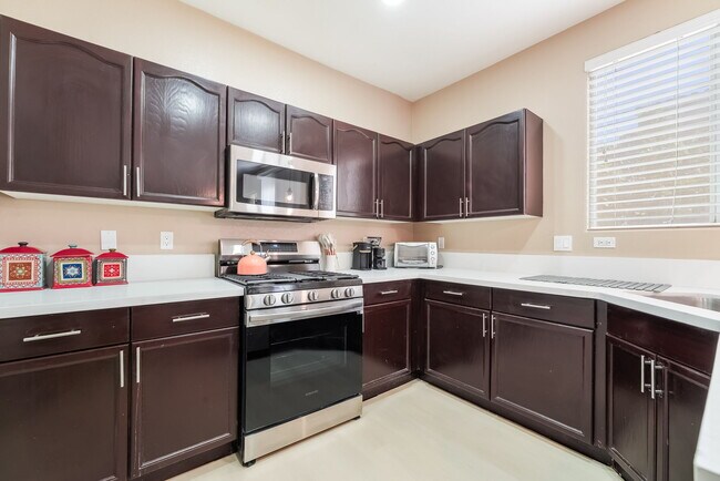 Kitchen featuring stainless steel appliances and dark brown cabinetry - 1179 Antoinette St
