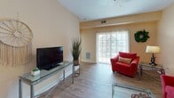 This single-floor residence on Offshore Dr in East Amherst, NY offers a thoughtfully designed layout with warm, neutral tones throughout. The living room features wood-look flooring, a sliding glass door that invites natural light and provides views of the surrounding neighborhood, and a ceiling fan overhead. The space flows naturally into a dedicated dining area, illuminated by a pendant light fixture and connected to a hallway leading to the rest of the home.

The kitchen is well-equipped with rich dark wood cabinetry, granite countertops, stainless steel appliances including a refrigerator, gas range, and built-in microwave, all set against wood-look flooring. Two bedrooms offer comfortable, carpeted retreats with warm wall tones. The primary bedroom benefits from a large window with neighborhood views, while a second bedroom provides a cozy, well-proportioned space.

Two bathrooms serve the home: a full primary bathroom featuring tile flooring, a walk-in shower, a double vanity with dark wood cabinetry, and a window for natural light, alongside a secondary bathroom with tile flooring and a shower-tub combination. The overall ambiance is warm, clean, and welcoming throughout.