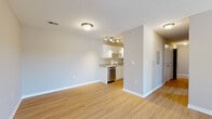 Located at 4727 Grant Line Rd in New Albany, Indiana, this single-floor residence offers a clean, modern aesthetic throughout. The open living area is finished with light hardwood-style flooring that extends seamlessly across the space, complemented by neutral-toned walls and bright flush-mount ceiling lighting. A ceiling fan and sliding glass door in the living room provide both comfort and access to the outdoors, filling the space with natural light.

The kitchen is efficiently designed and equipped with white shaker-style cabinetry, granite-look countertops, and a full suite of stainless steel appliances including a refrigerator, electric range, over-the-range microwave, and dishwasher. Track lighting above the kitchen adds focused illumination to the workspace.

The bedrooms are generously proportioned with the same hardwood-style flooring, neutral walls, and windows fitted with blinds that allow for ample natural light and outdoor views. The bathroom features a white vanity with under-cabinet storage, a large mirror, and a combined tub and shower unit, all maintained in a clean and functional layout.

Overall, this unit presents a well-maintained, move-in-ready interior with consistent finishes throughout, offering a comfortable and practical living environment in New Albany, IN.