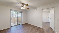 Located in Austin, TX (78752), this one-bedroom, one-bathroom unit offers a well-organized single-floor layout designed to maximize functionality. Hardwood-style flooring runs throughout the entire space, providing a cohesive and clean aesthetic from room to room.

The living room serves as the central gathering area and is enhanced by crown molding, a ceiling fan with integrated lighting, and a sliding glass door that opens to a private balcony — allowing natural light to filter in and providing outdoor views of the surrounding area.

The kitchen features dark cabinetry that contrasts neatly against light countertops and white appliances, including a refrigerator and range. A window above the sink brings in additional natural light, keeping the space bright and practical.

The bedroom is a comfortable, well-proportioned room with crown molding, a ceiling fan, and a large window fitted with blinds for light control. A dedicated closet provides convenient storage. The bathroom includes a full tub-shower combination with white tile surround, offering a clean and straightforward design.

Throughout the unit, neutral wall tones, consistent flooring, and classic trim details create a unified and livable atmosphere suited for everyday comfort in the heart of Austin.