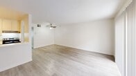 Located on the second floor at 20939 Parthenia St in Canoga Park, CA, this one-bedroom, one-bathroom unit offers a well-organized layout across a single floor. The living room serves as the central gathering space, featuring light wood-style laminate flooring, a ceiling fan, a textured ceiling, and a large sliding glass door fitted with vertical blinds that allows generous natural light to fill the room. The open entry area transitions smoothly into the living space, maintaining a clean, neutral aesthetic throughout.

The galley-style kitchen runs parallel along one side of the unit, equipped with white cabinetry, white countertops, a stainless steel refrigerator, an electric range, a dishwasher, and a single-basin sink — offering efficient functionality within a compact footprint.

The bedroom is a comfortable, well-proportioned space with soft carpeting, white walls, a textured ceiling, and a window dressed with vertical blinds that provides natural light. A dedicated closet offers practical storage.

The bathroom includes a full tub-and-shower combination with a curtain rod, a white vanity with sink, a toilet, and wood-style flooring, maintaining the unit's consistent, clean design. A hallway connects the primary spaces, contributing to the unit's efficient and straightforward flow.