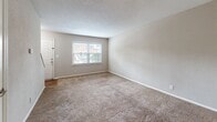 Located at 300 Pelham Rd in Greenville, SC, this two-floor residence offers a well-organized layout with a practical mix of finishes throughout. The main level features warm hardwood-style flooring that flows through the living and kitchen areas, creating a cohesive and inviting atmosphere. The living room is generously proportioned, featuring neutral-toned walls, a textured ceiling, and a window that draws in natural light with views of the surrounding neighborhood. The kitchen is a functional highlight, showcasing crisp white shaker-style cabinetry, granite-look countertops, a stainless steel range and dishwasher, and a window that adds brightness to the space. Adjacent to the kitchen is a dedicated laundry area with washer/dryer hookups, accessible through its own door. The upper level houses multiple carpeted bedrooms finished in warm neutral tones, each offering a calm and comfortable retreat. The bedrooms are connected by a hallway and benefit from windows overlooking lush greenery. The bathroom includes a full tub-and-shower combination with white tile surround and chrome fixtures. Throughout the home, clean white trim and consistent neutral color palettes provide a move-in-ready canvas.