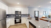 Located at 1 Rock Pointe Pl in Rockaway, NJ, this well-appointed one-bedroom, one-bathroom residence offers a thoughtfully designed single-level layout with modern finishes throughout. The open-concept living and dining area features warm hardwood-style flooring, recessed lighting, and large windows that invite an abundance of natural light. A private balcony door extends the living space outdoors, while soft, neutral wall tones create a calm and welcoming ambiance. The kitchen is outfitted with crisp white shaker cabinetry, granite countertops, a classic subway tile backsplash, and a full suite of stainless steel appliances, including a gas range, over-the-range microwave, and refrigerator. A breakfast bar provides additional seating and connects seamlessly to the dining area. The bedroom is a comfortable retreat featuring plush carpeting, a ceiling fan, a bold accent wall, and a generous walk-in closet equipped with wire shelving and hanging rods for ample storage. The bathroom includes a soaking tub with a subway-tiled surround and polished chrome fixtures. A dedicated hallway and additional closet space add everyday convenience, rounding out this functional and stylish Rockaway residence.