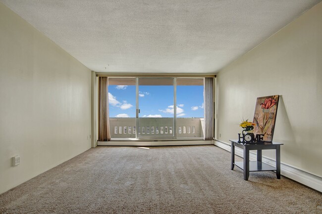 A living room with wide sliding glass doors - Marquis Towers