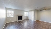 Located at 2624 S Miller Dr in Lakewood, Colorado, this single-floor, 2-bedroom, 2-bathroom home offers a well-organized layout across a comfortable footprint. The living room serves as the centerpiece of the space, showcasing rich dark hardwood-style flooring, a classic brick fireplace, and multiple windows that allow natural light to fill the room. Sliding glass doors with vertical blinds open directly onto a private balcony, extending the living area outdoors. A ceiling fan adds comfort and functionality to the space.

The kitchen features white shaker-style cabinetry, light countertops, and black appliances including a refrigerator, range, and over-the-range microwave. A pass-through window connects the kitchen to the living area, enhancing the open feel between the two spaces.

Both bedrooms are carpeted and well-lit by natural light from exterior windows. The spacious primary bedroom provides ample room for furnishings, while each bedroom benefits from dedicated closet storage. The two bathrooms are clean and functional, with one featuring a granite-topped vanity, brushed nickel hardware, and a tiled tub-shower combination. A dedicated in-unit laundry room adds everyday convenience. Textured ceilings and neutral gray walls are consistent throughout, creating a cohesive, move-in-ready environment.