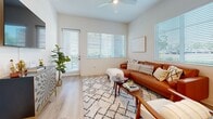 Located at 11821 Skylark Cir in Whittier, CA, this single-story 2-bedroom, 2-bathroom home offers a thoughtfully designed layout with modern finishes throughout. Light-toned luxury vinyl plank flooring flows through the main living areas, complemented by neutral walls and abundant natural light from multiple windows.

The living room is bright and welcoming, featuring a ceiling fan, large windows with outdoor views, and direct access to an exterior door, creating an airy, open feel. Adjacent to it, the kitchen is well-equipped with white shaker cabinetry, a white subway tile backsplash, stainless steel appliances including a gas range, microwave, dishwasher, and refrigerator, plus ample counter space. A dedicated dining area with a round table completes the kitchen space.

Both bathrooms feature clean white vanities with illuminated mirrors and wood-look tile flooring, offering a fresh, modern aesthetic. The primary bedroom is generously sized with plush carpeting and ceiling-height walls, while the second bedroom is similarly comfortable, featuring a ceiling fan, large window with garden views, and soft carpet.

A hallway connects the bedrooms and bathrooms efficiently, with a closet providing additional storage. The home's cohesive design, modern upgrades, and single-floor accessibility make it a highly functional and attractive residence.